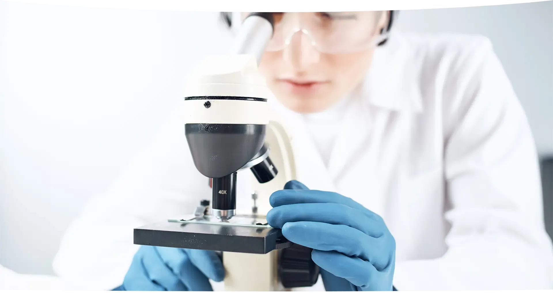female doctor microscope probe