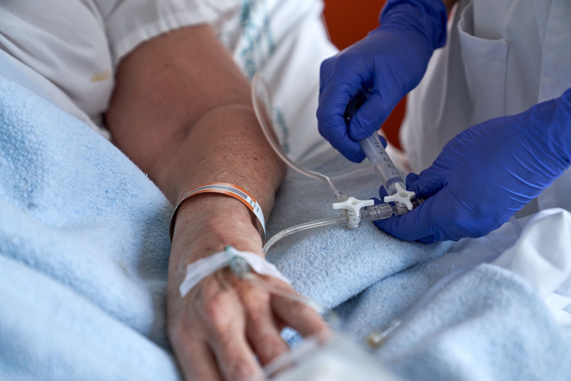 crop-nurse-injecting-patient-with-drug-intravenous